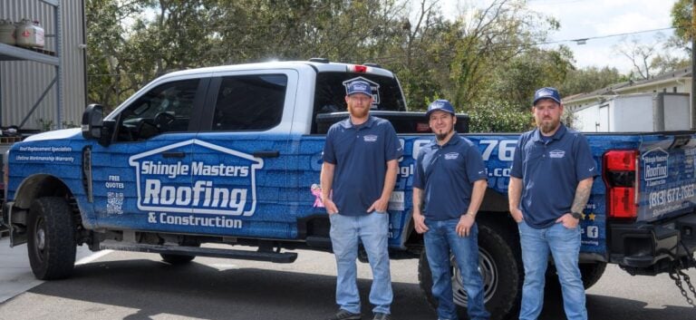 Shingle Masters team in front of a company car