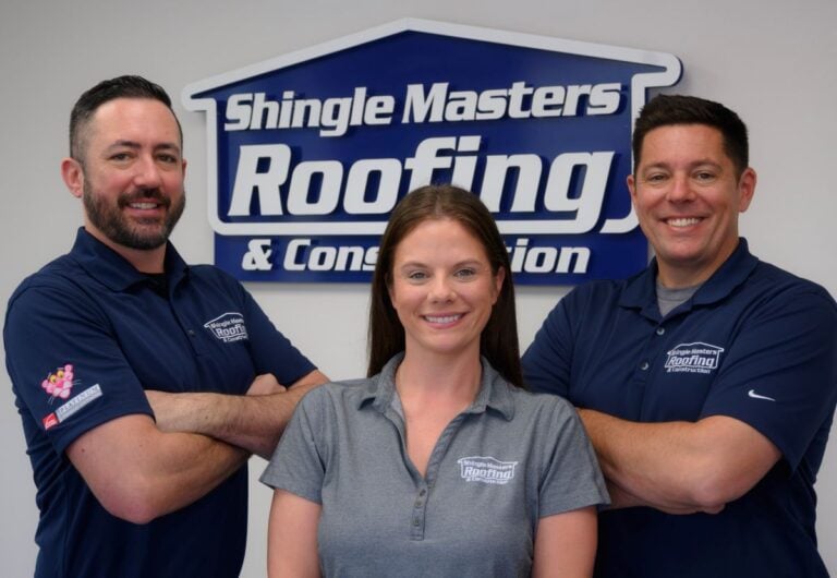 Shingle Masters team in front of company logo