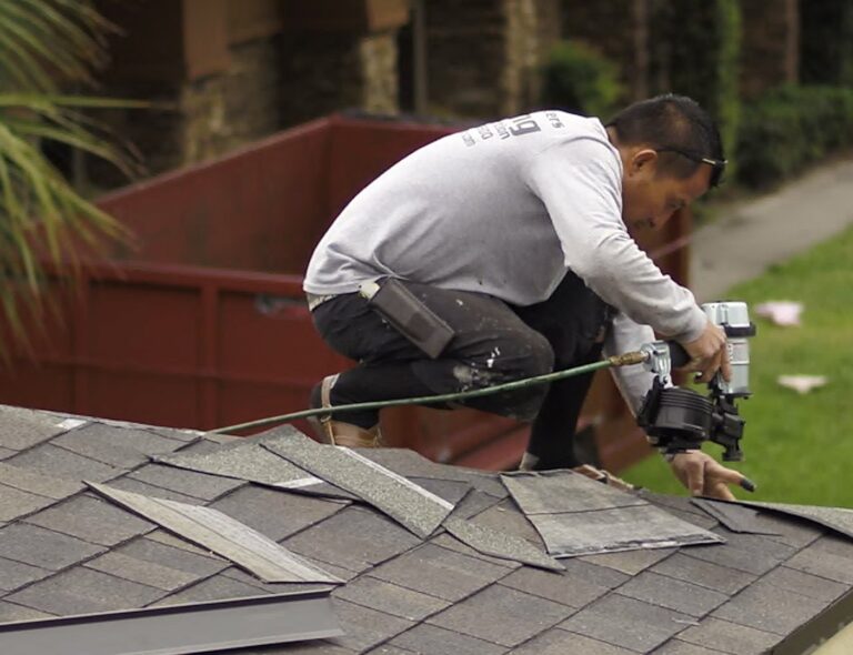 Shingle Masters team member working on a roof