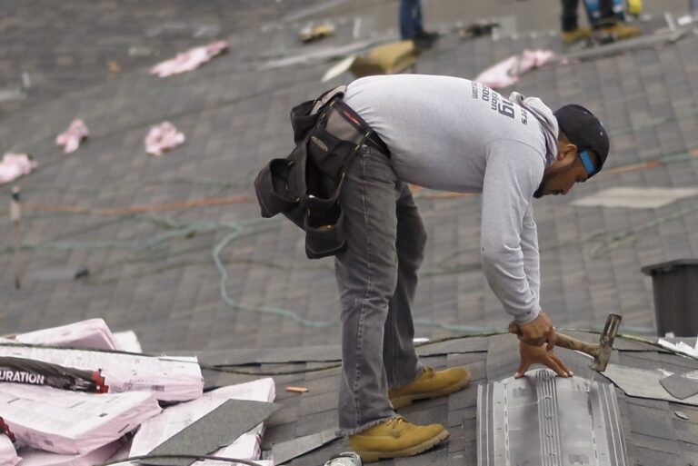Shingle Masters team member working on a roof