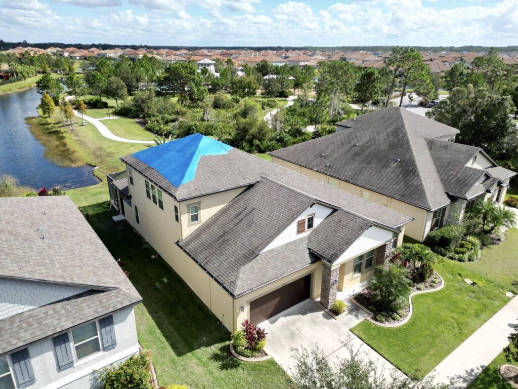 Roof with a tarp after storm damage