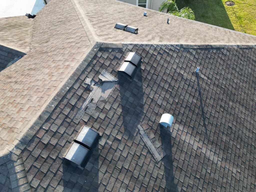 A roof with missing shingles after storm damage