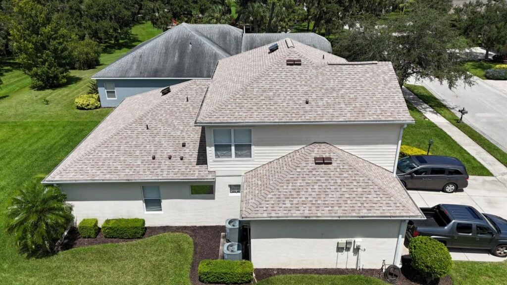 A white house with a new shingle roof