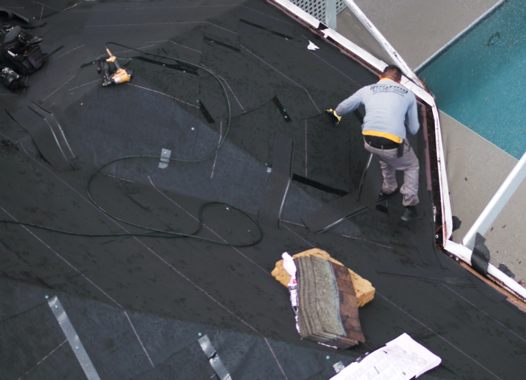 Shingle Masters team member working on a roof