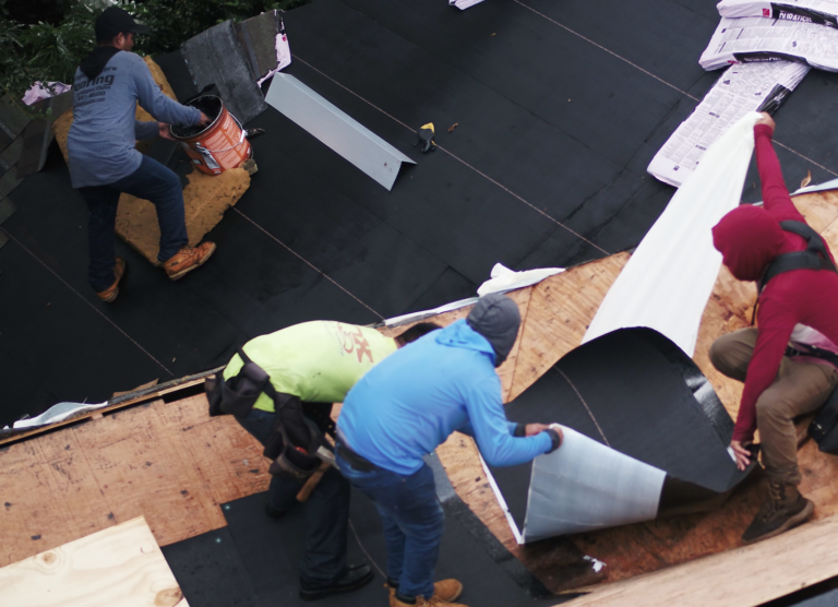 Shingle Masters team working together to install new shingles on a roof