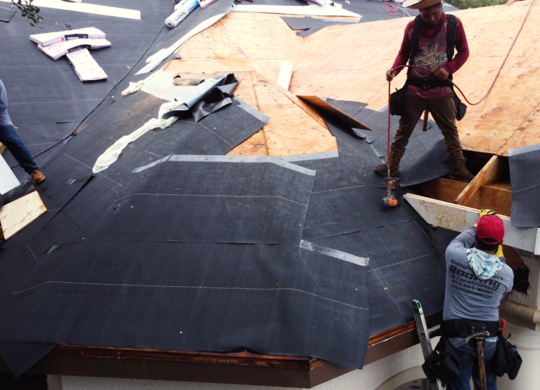 Shingle Masters team preparing a roof for shingle installation