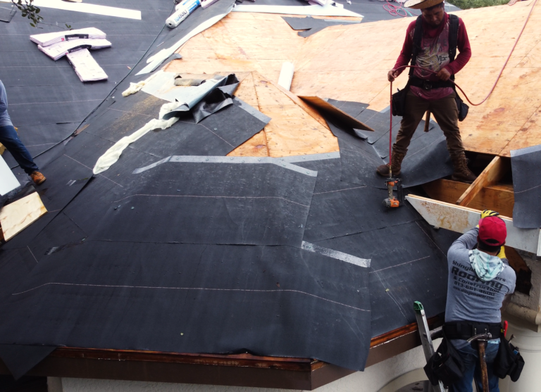 Shingle Masters team preparing a roof for shingle installation