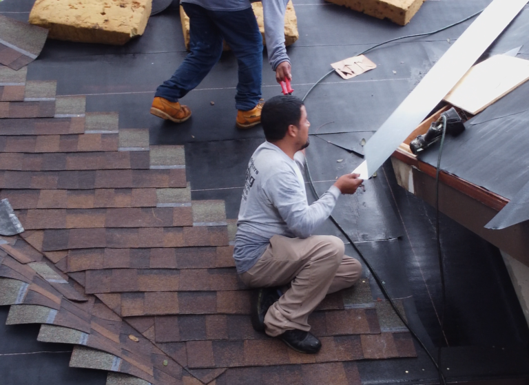 Shingle Masters team installing shingles