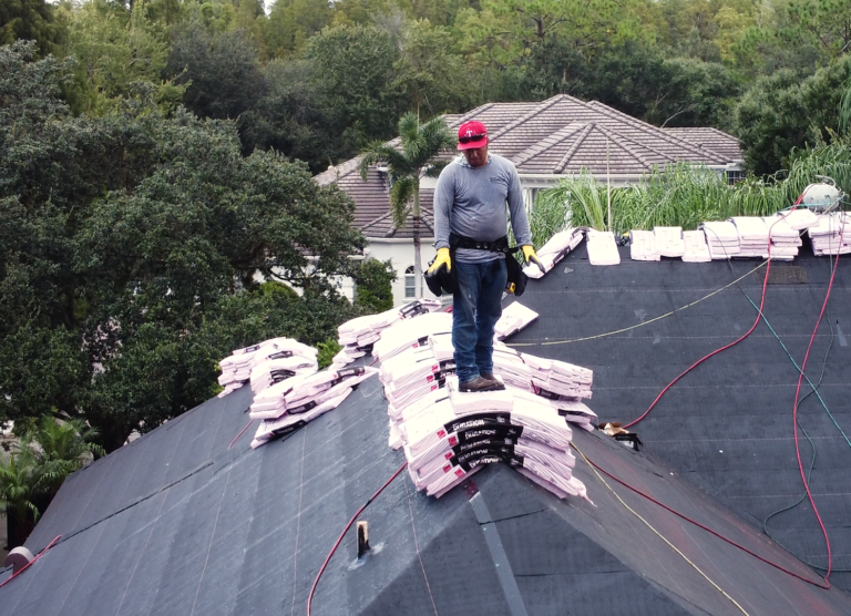 Shingle Masters team member standing on a roof