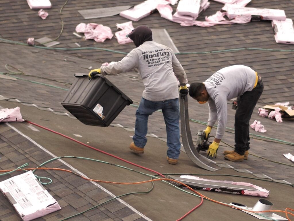Two workers on a roof