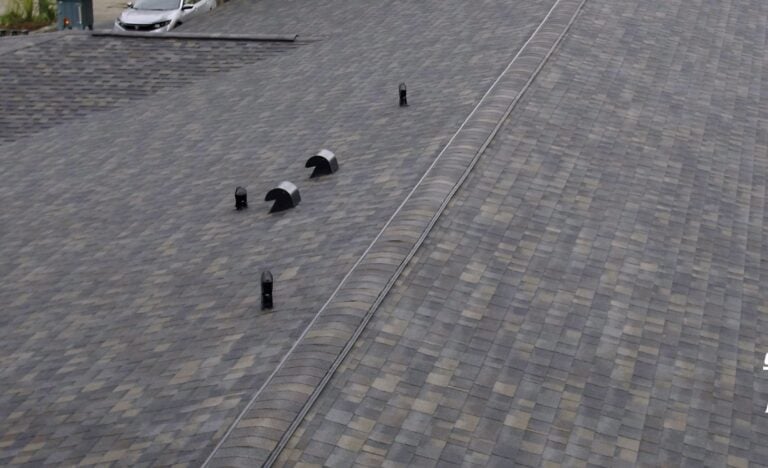 A close-up view of a sloped, shingled roof