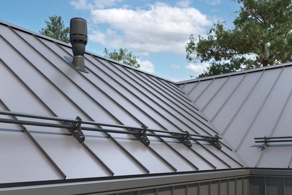 Close-up house retro roof panel with standing seam and fasteners. Classic style black metal panel with rebate joint. Modern galvanized steel roofing sheet with ribs.